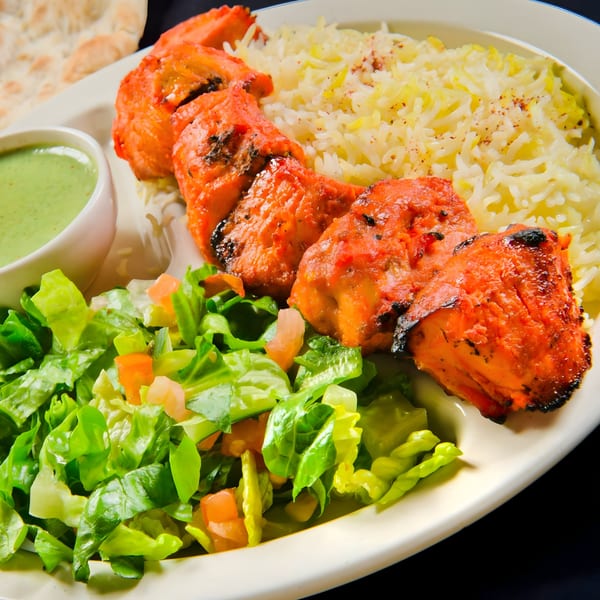 Mimi's Kabob chicken tikka with rice, green salad, and a side of green chutney.